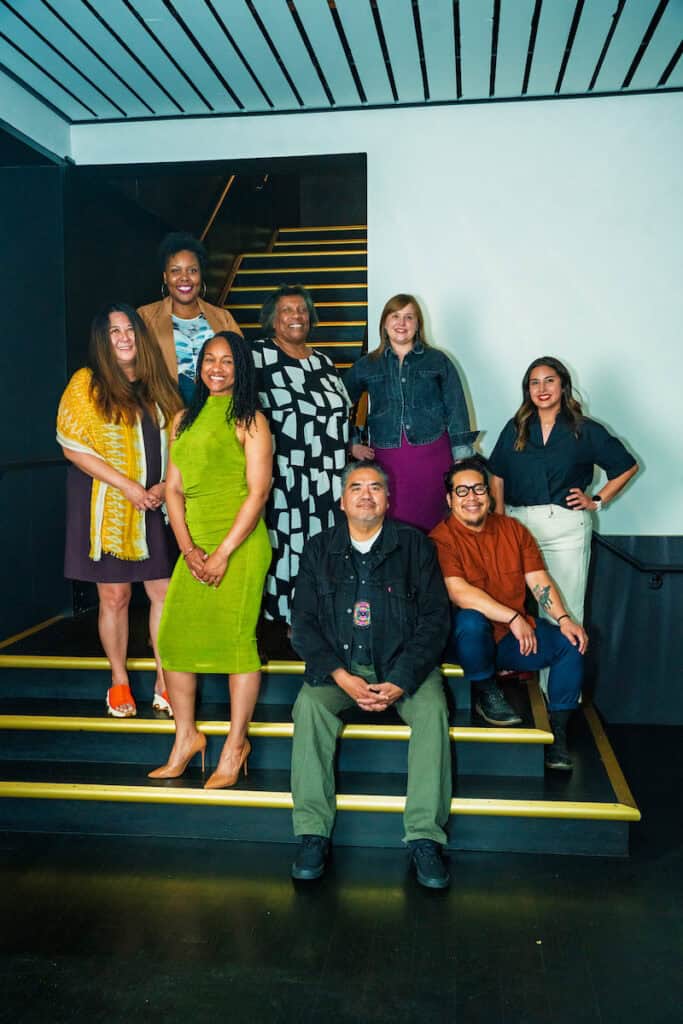 2025 Leaders for a New Chicago awardees gathered on geometric yellow and black steps