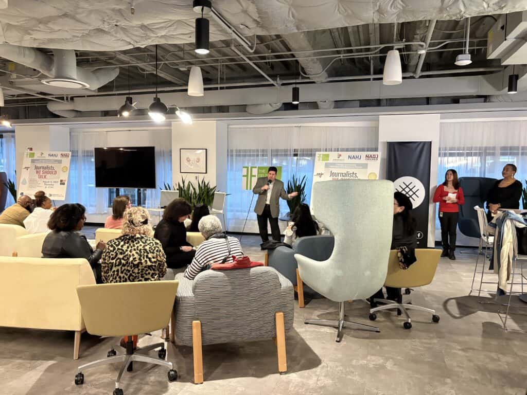 Speaker presenting to journalists and attendees seated in modern event space during the Chicago Journalists Wellness and Resource Forum hosted by Field Foundation at Impact House