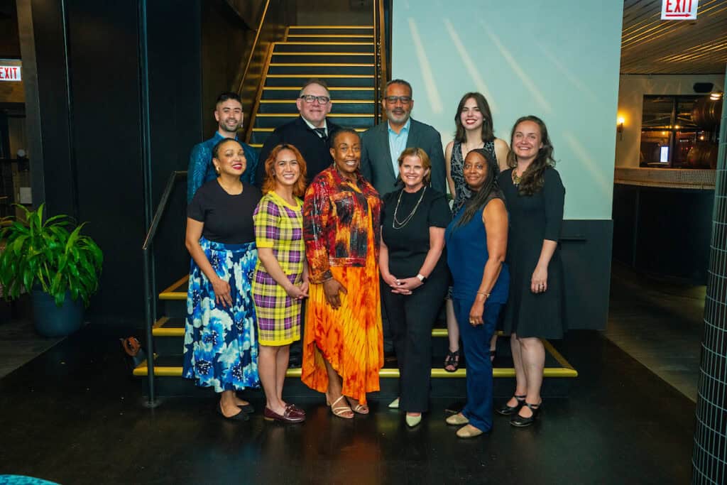 Field Foundation staff gathered on geometric yellow and black steps